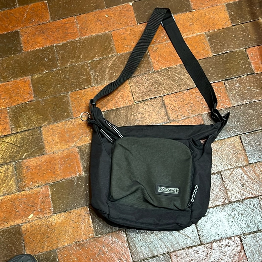 Lands’ End black canvas shoulder bag approximately 14” wide by 11” high.